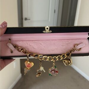 Juicy Couture charm bracelet with 3 additional charms.